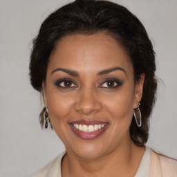 Joyful black young-adult female with medium  brown hair and brown eyes