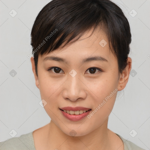 Joyful asian young-adult female with short  brown hair and brown eyes