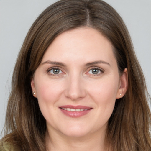 Joyful white young-adult female with long  brown hair and grey eyes