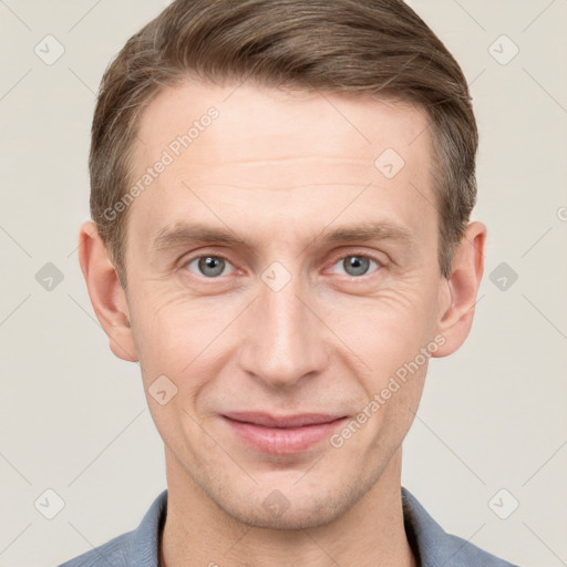 Joyful white adult male with short  brown hair and grey eyes