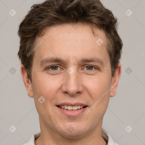 Joyful white adult male with short  brown hair and grey eyes