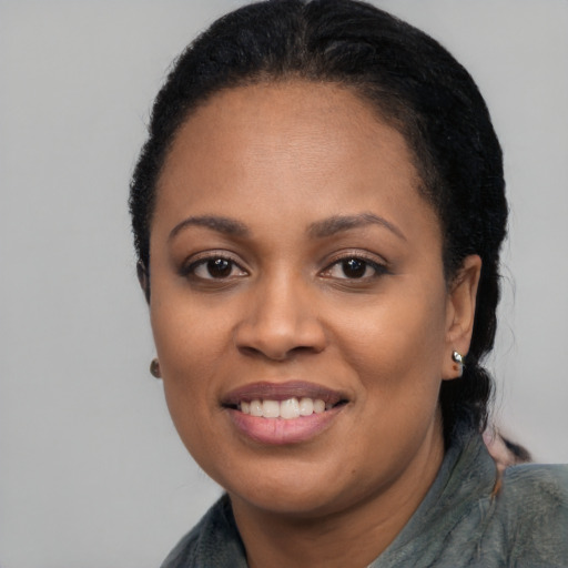 Joyful black young-adult female with medium  black hair and brown eyes