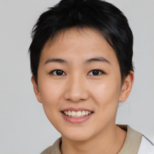 Joyful asian young-adult female with short  brown hair and brown eyes