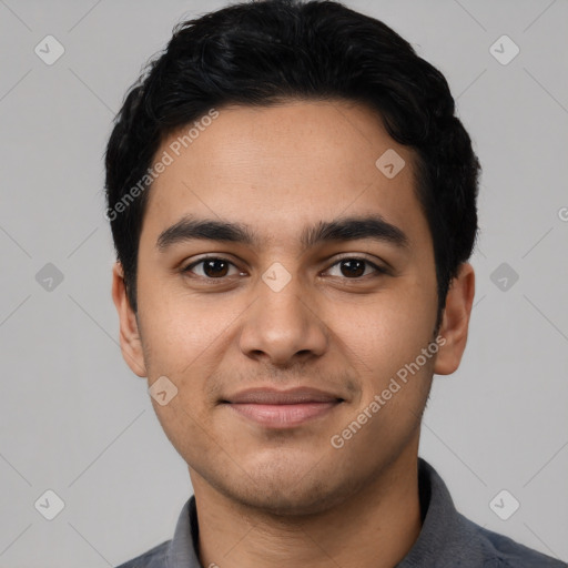 Joyful latino young-adult male with short  black hair and brown eyes