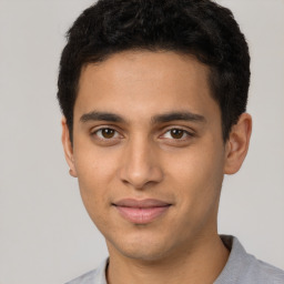 Joyful latino young-adult male with short  brown hair and brown eyes