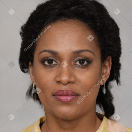 Joyful black adult female with medium  brown hair and brown eyes