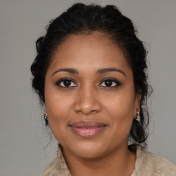 Joyful black young-adult female with medium  brown hair and brown eyes