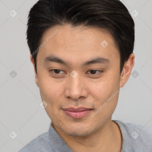 Joyful asian young-adult male with short  brown hair and brown eyes