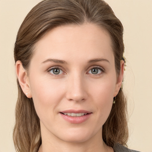 Joyful white young-adult female with medium  brown hair and grey eyes