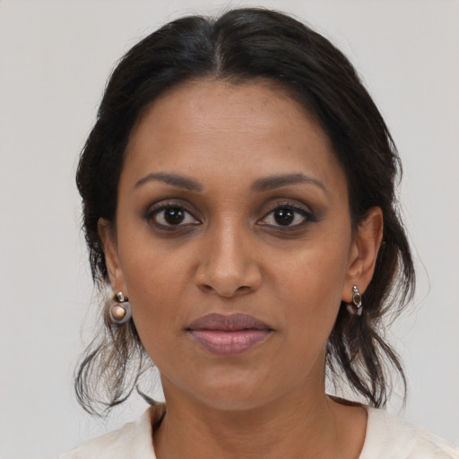 Joyful black young-adult female with medium  brown hair and brown eyes