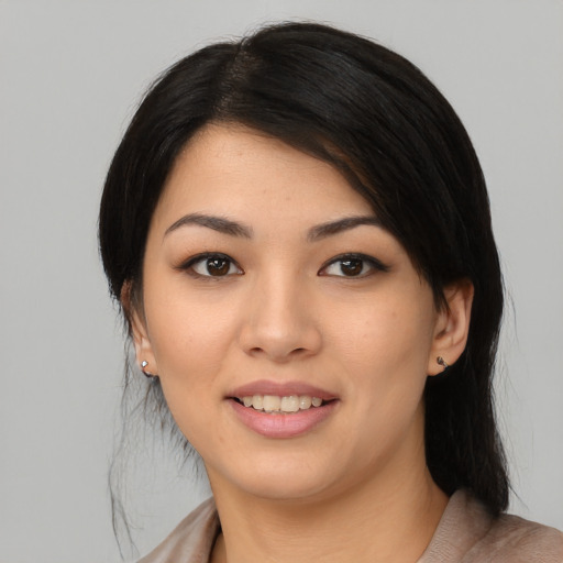 Joyful asian young-adult female with medium  black hair and brown eyes