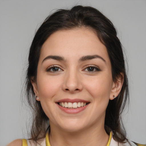 Joyful white young-adult female with medium  brown hair and brown eyes