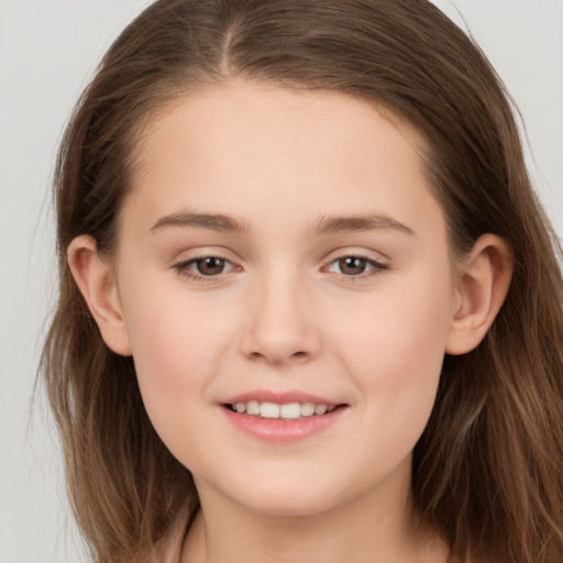 Joyful white child female with long  brown hair and brown eyes