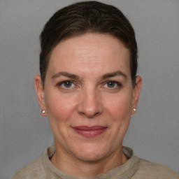 Joyful white adult female with short  brown hair and grey eyes