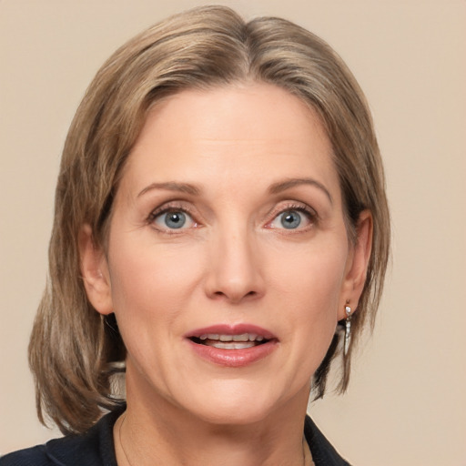 Joyful white adult female with medium  brown hair and grey eyes