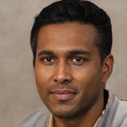 Joyful black young-adult male with short  black hair and brown eyes