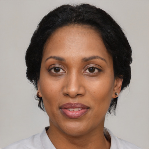 Joyful black adult female with medium  black hair and brown eyes