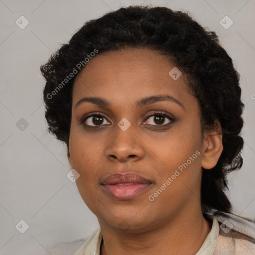 Joyful black young-adult female with long  brown hair and brown eyes