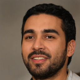 Joyful latino young-adult male with short  black hair and brown eyes