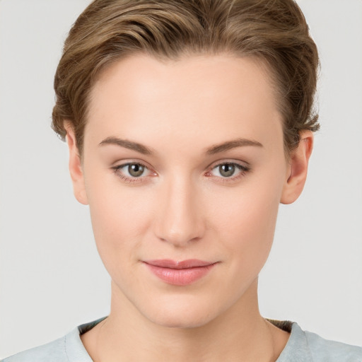 Joyful white young-adult female with short  brown hair and grey eyes