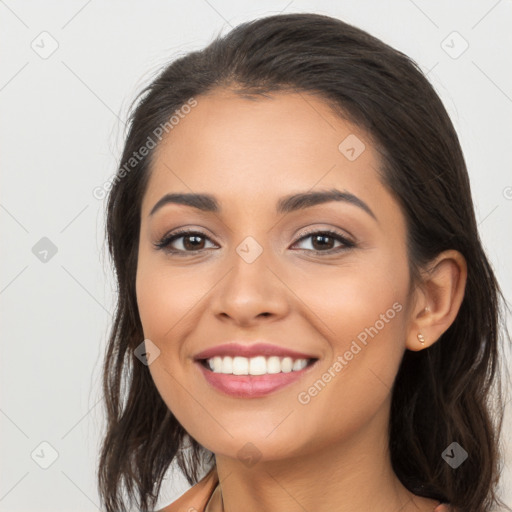 Joyful latino young-adult female with long  brown hair and brown eyes