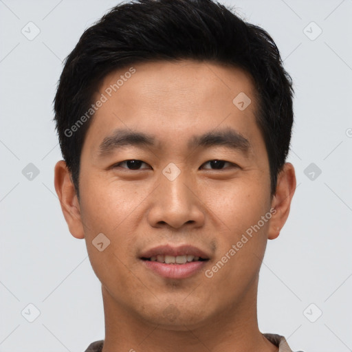 Joyful asian young-adult male with short  black hair and brown eyes