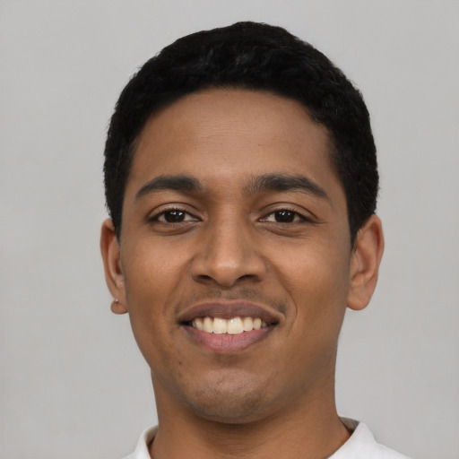 Joyful latino young-adult male with short  black hair and brown eyes