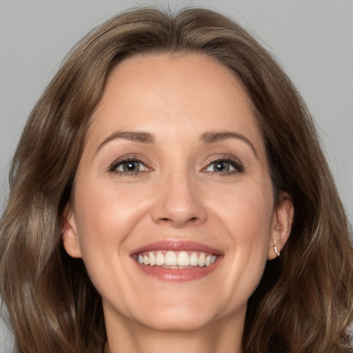 Joyful white adult female with medium  brown hair and brown eyes