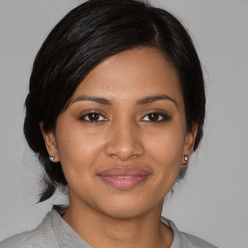 Joyful black young-adult female with medium  brown hair and brown eyes