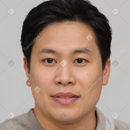 Joyful asian young-adult male with short  brown hair and brown eyes