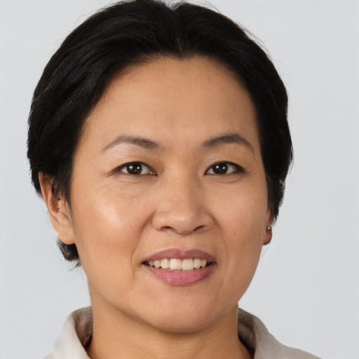 Joyful asian adult female with short  brown hair and brown eyes