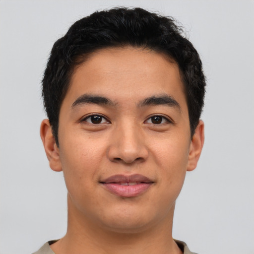 Joyful asian young-adult male with short  brown hair and brown eyes