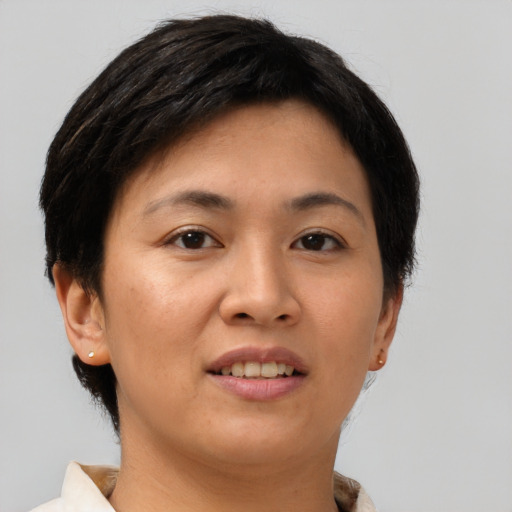 Joyful asian young-adult female with short  brown hair and brown eyes