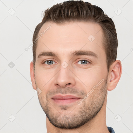 Joyful white young-adult male with short  brown hair and brown eyes