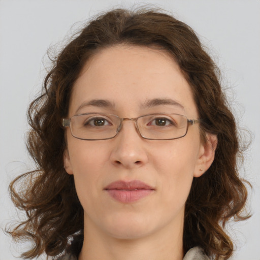 Joyful white adult female with medium  brown hair and green eyes