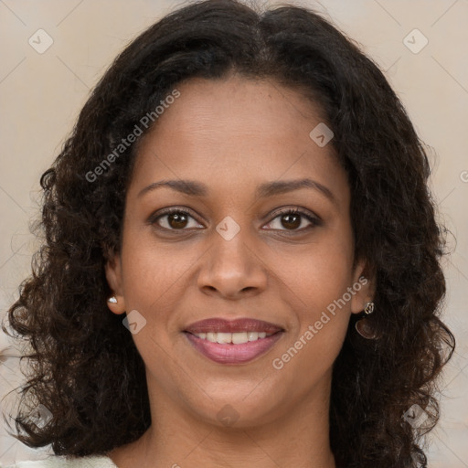 Joyful black young-adult female with long  brown hair and brown eyes