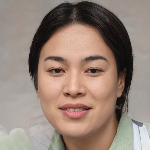 Joyful asian young-adult female with medium  brown hair and brown eyes