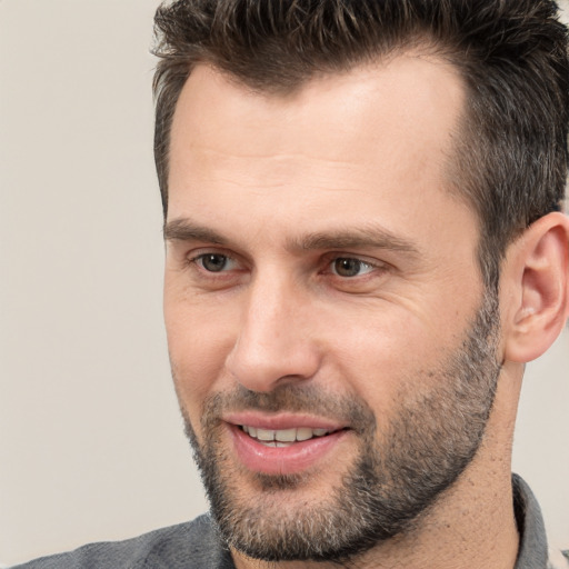 Joyful white adult male with short  brown hair and brown eyes