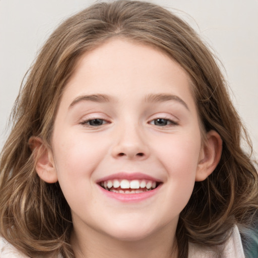 Joyful white child female with long  brown hair and grey eyes