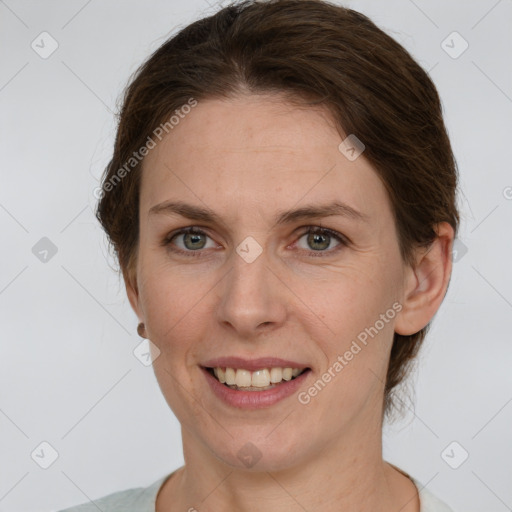 Joyful white adult female with short  brown hair and grey eyes