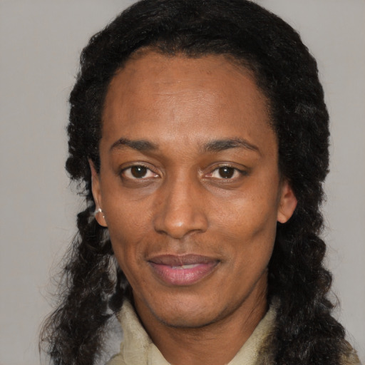 Joyful black adult female with long  black hair and brown eyes