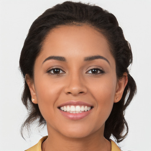 Joyful latino young-adult female with medium  brown hair and brown eyes