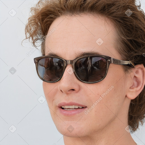 Joyful white adult female with medium  brown hair and blue eyes