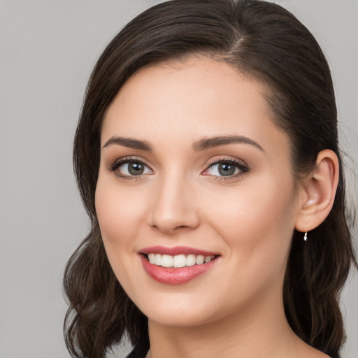 Joyful white young-adult female with medium  brown hair and brown eyes