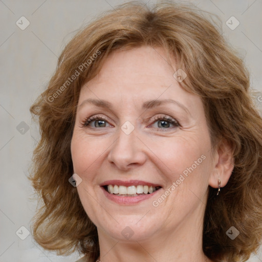 Joyful white adult female with medium  brown hair and blue eyes