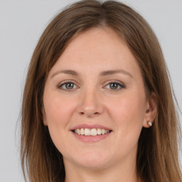 Joyful white young-adult female with long  brown hair and grey eyes