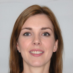 Joyful white young-adult female with long  brown hair and grey eyes