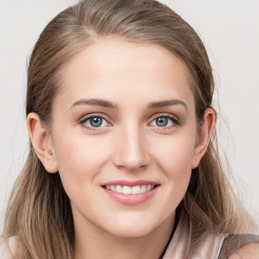 Joyful white young-adult female with long  brown hair and grey eyes