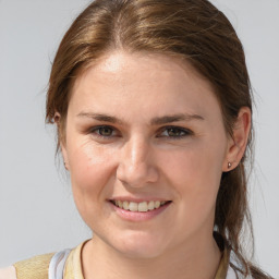 Joyful white young-adult female with medium  brown hair and blue eyes