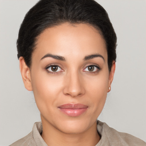 Joyful latino young-adult female with short  brown hair and brown eyes